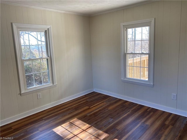 empty room with ornamental molding and dark hardwood / wood-style floors