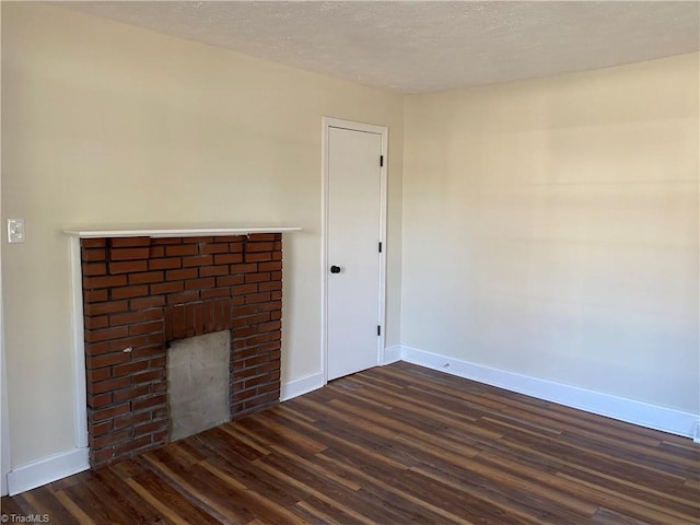 unfurnished living room with dark hardwood / wood-style floors and a fireplace