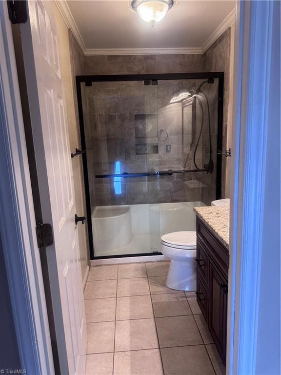 bathroom featuring tile patterned flooring, crown molding, and a shower stall