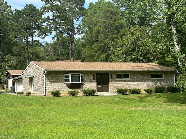 ranch-style home with a garage and a front yard