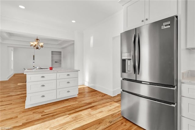 kitchen featuring white cabinetry, light stone countertops, an inviting chandelier, stainless steel fridge with ice dispenser, and light hardwood / wood-style floors