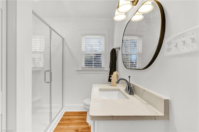 bathroom featuring hardwood / wood-style floors, vanity, toilet, and an enclosed shower