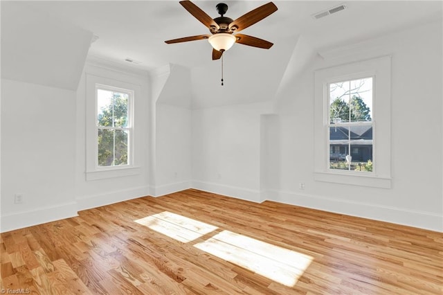 bonus room with ceiling fan, a healthy amount of sunlight, vaulted ceiling, and light hardwood / wood-style flooring