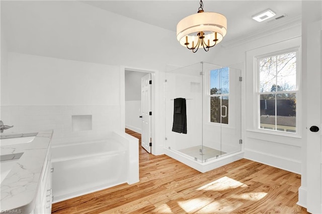 interior space with sink, a notable chandelier, separate shower and tub, wood-type flooring, and ornamental molding