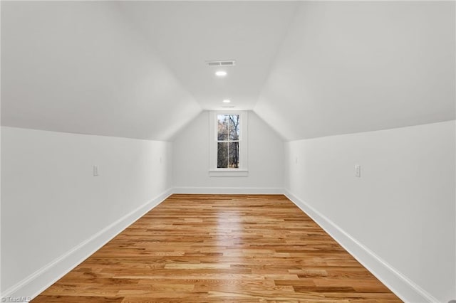 bonus room with light hardwood / wood-style floors and vaulted ceiling