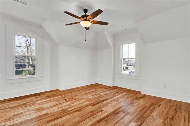 additional living space featuring plenty of natural light, light hardwood / wood-style floors, and ceiling fan