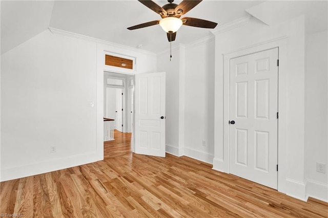 unfurnished bedroom featuring ceiling fan, crown molding, and light hardwood / wood-style floors