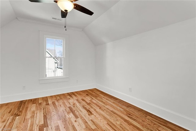 additional living space with hardwood / wood-style flooring, ceiling fan, and vaulted ceiling