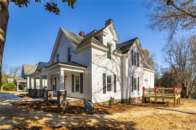 view of property exterior with covered porch