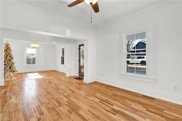 unfurnished living room featuring hardwood / wood-style flooring, ceiling fan with notable chandelier, and crown molding