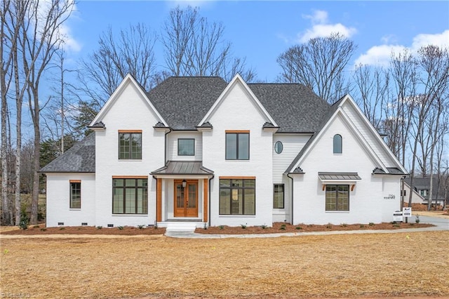 view of front of home with brick siding and roof with shingles