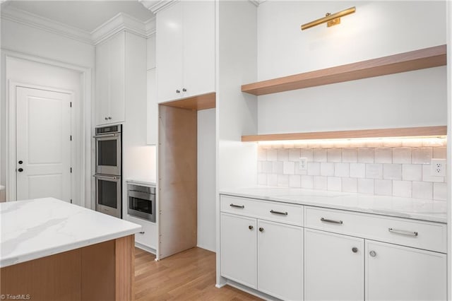 kitchen featuring stainless steel double oven, open shelves, decorative backsplash, white cabinets, and crown molding