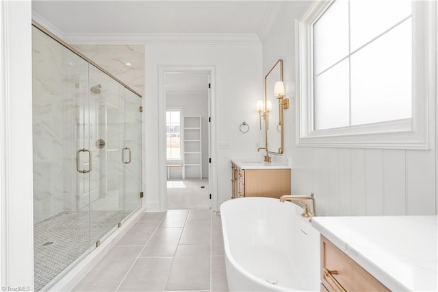 bathroom featuring a marble finish shower, tile patterned flooring, ornamental molding, a soaking tub, and vanity