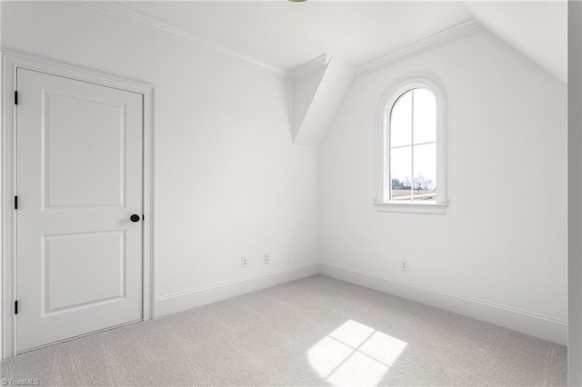 additional living space featuring carpet flooring, baseboards, and vaulted ceiling