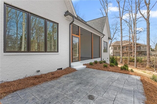 view of patio with a sunroom