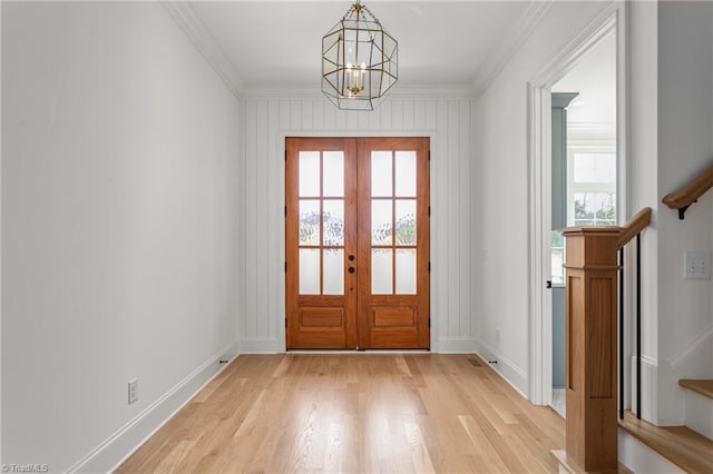 doorway to outside with light wood-type flooring, french doors, crown molding, baseboards, and a chandelier