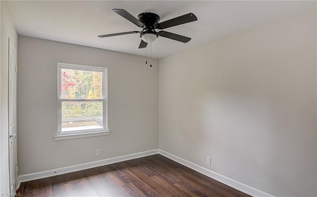 empty room with dark hardwood / wood-style floors and ceiling fan