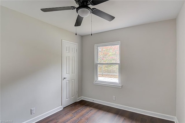 unfurnished room with ceiling fan and dark wood-type flooring