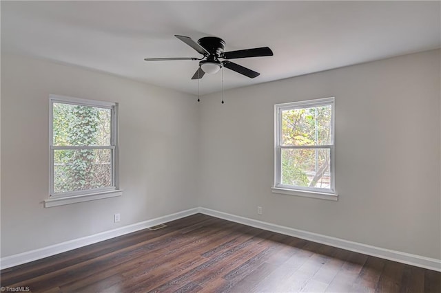 spare room featuring ceiling fan and dark wood-type flooring