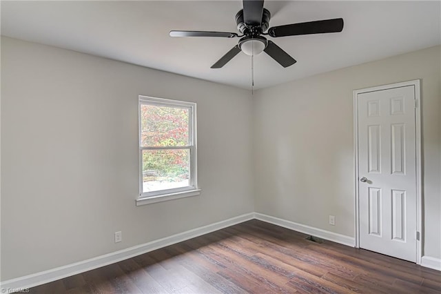 unfurnished room with ceiling fan and dark hardwood / wood-style flooring