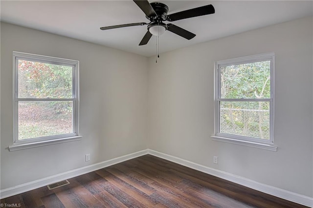 empty room with dark hardwood / wood-style floors and ceiling fan