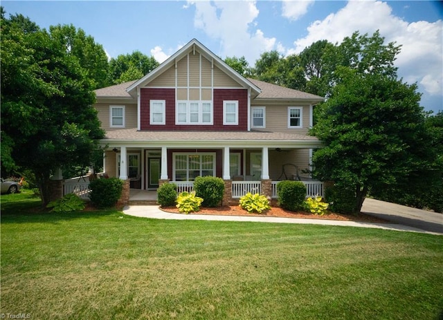 craftsman inspired home featuring a porch and a front lawn