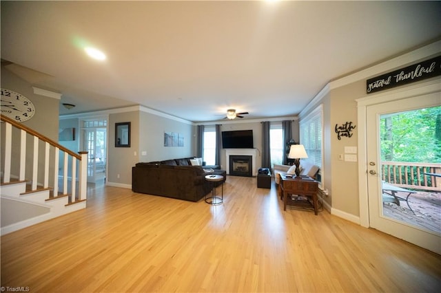 living room with ceiling fan, light hardwood / wood-style floors, and ornamental molding