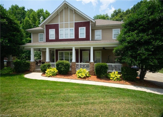 craftsman-style house featuring covered porch and a front yard