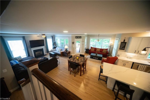 living room with ceiling fan and light hardwood / wood-style flooring