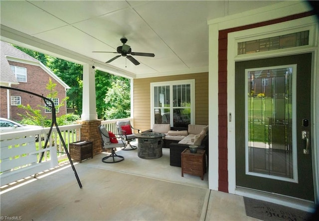 view of patio featuring a porch, an outdoor living space with a fire pit, and ceiling fan