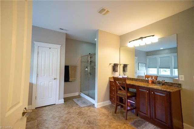 bathroom featuring vanity and a shower with door