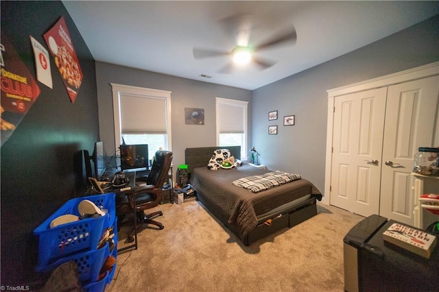 carpeted bedroom with a closet and ceiling fan