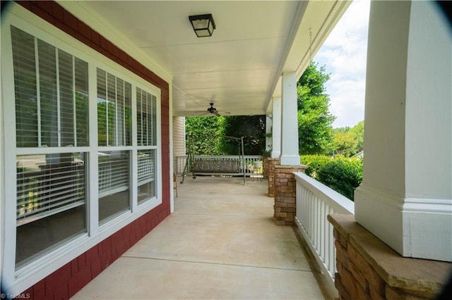 view of patio with ceiling fan and a porch