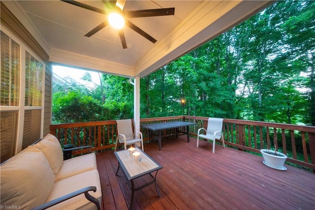 wooden terrace featuring an outdoor living space and ceiling fan