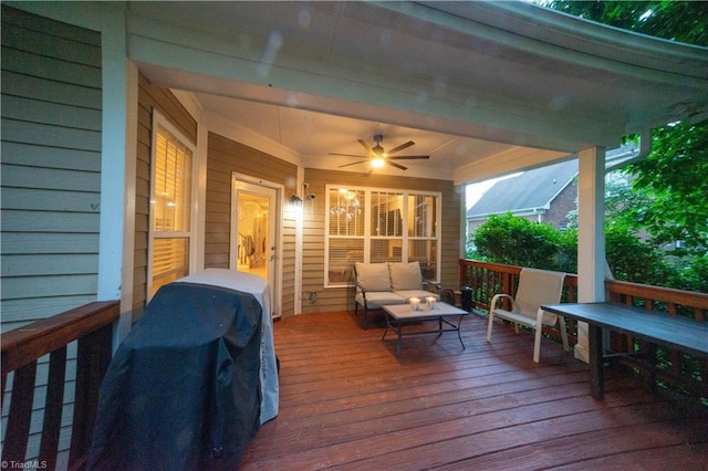 wooden terrace with ceiling fan and an outdoor living space