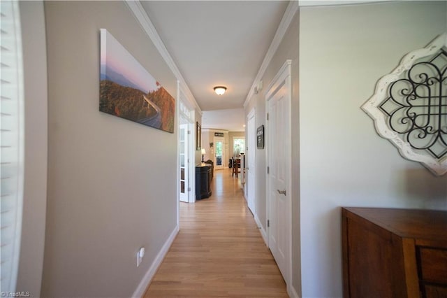 hall featuring light wood-type flooring and ornamental molding