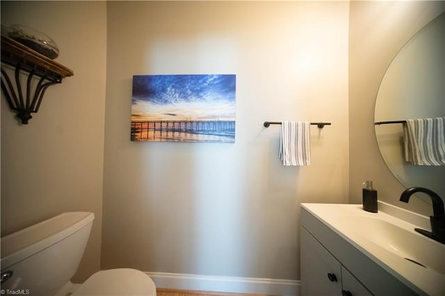 bathroom featuring vanity and toilet