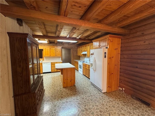 kitchen with visible vents, under cabinet range hood, light countertops, beam ceiling, and white appliances