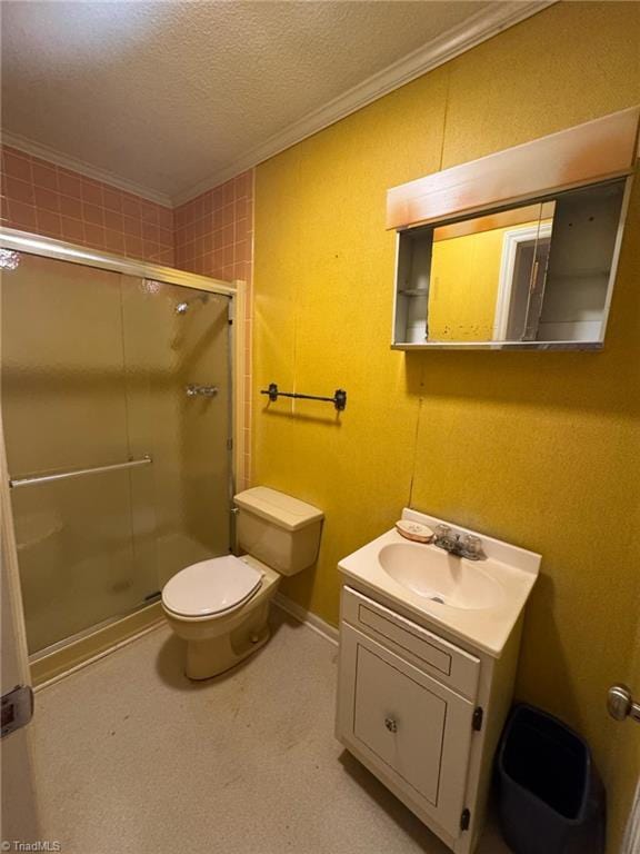 full bath with vanity, a textured ceiling, a shower stall, and crown molding