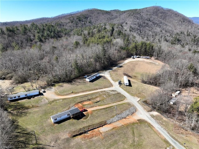 aerial view with a rural view, a mountain view, and a forest view