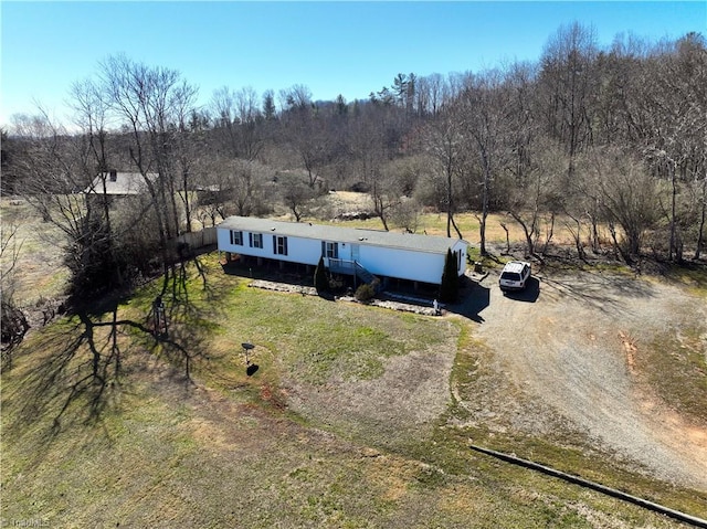 drone / aerial view featuring a view of trees