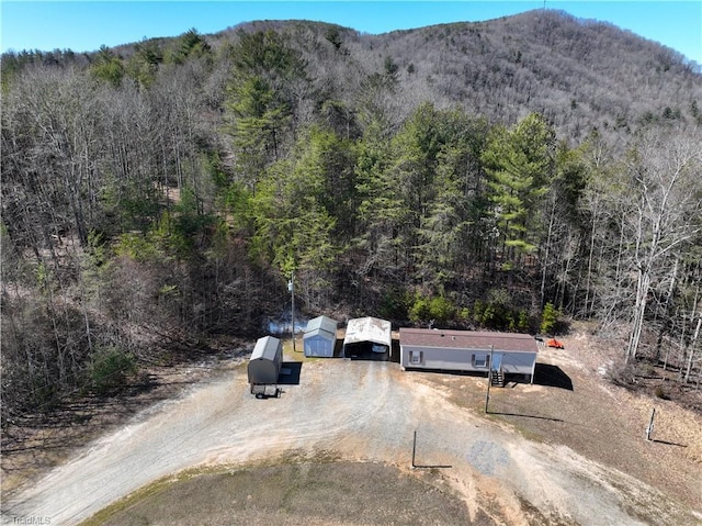 aerial view with a view of trees and a mountain view