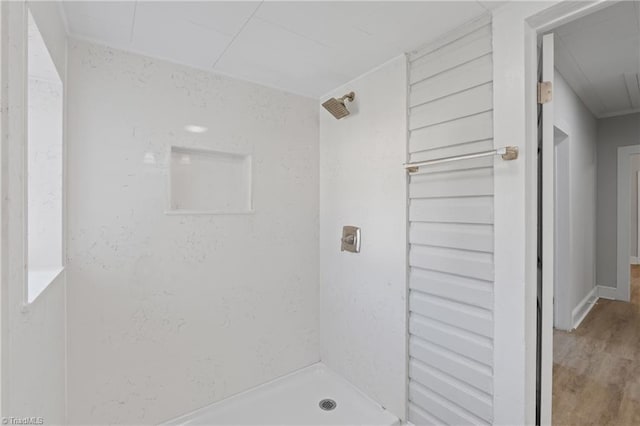 bathroom featuring a shower and hardwood / wood-style flooring