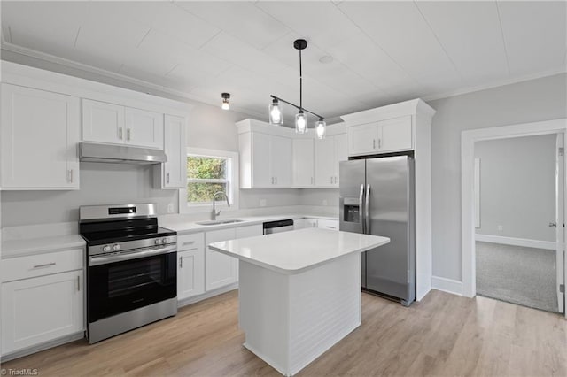 kitchen featuring white cabinetry, sink, decorative light fixtures, appliances with stainless steel finishes, and light wood-type flooring