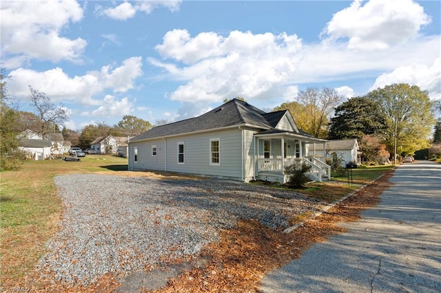 view of side of property featuring a porch