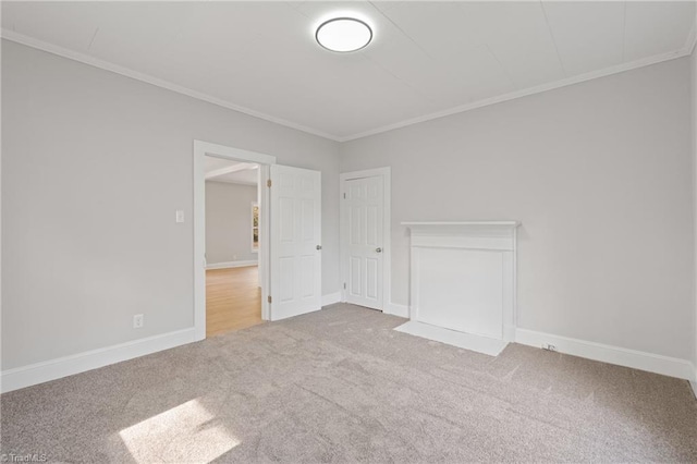 empty room featuring light colored carpet and ornamental molding