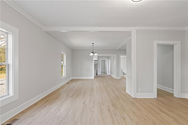 unfurnished living room with a chandelier, crown molding, and light hardwood / wood-style floors