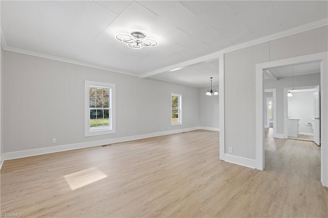 unfurnished living room with a chandelier, light wood-type flooring, and crown molding