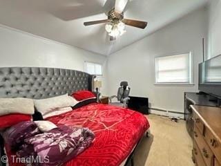 bedroom with a baseboard heating unit, light colored carpet, vaulted ceiling, and a ceiling fan