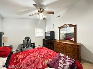 carpeted bedroom featuring baseboards and ceiling fan